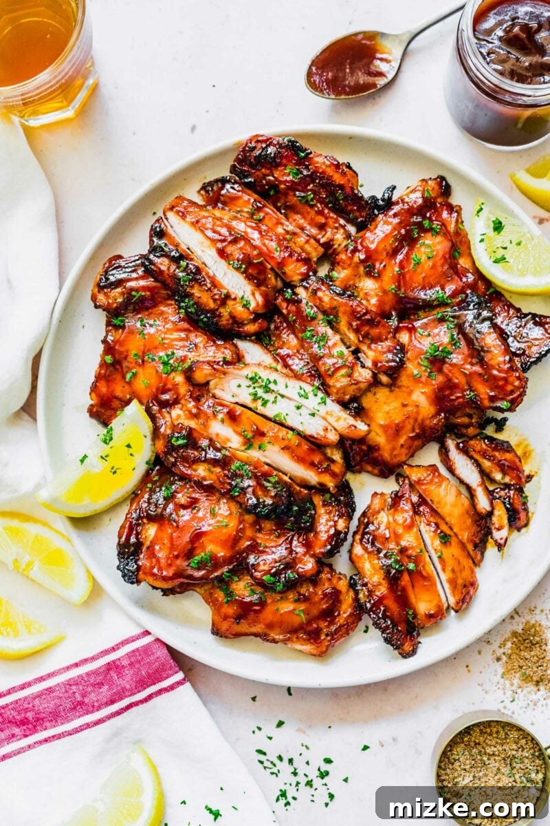 Classic Grilled BBQ Chicken 4 A plate of boneless skinless chicken thighs generously seasoned with a dry BBQ rub.