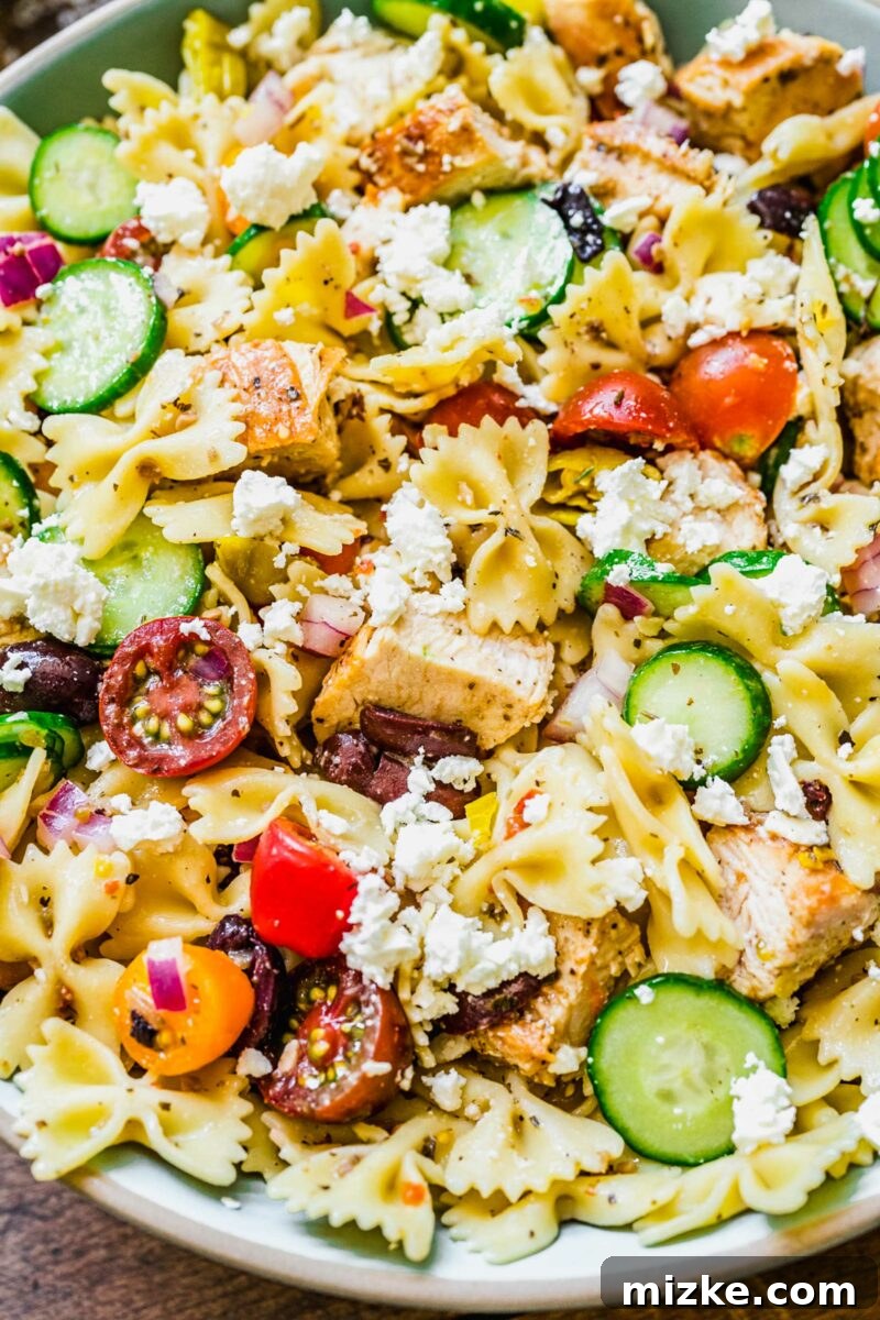 Zesty Greek Chicken Pasta Salad 5 A close-up shot of the Greek Chicken Pasta Salad shows all the ingredients perfectly tossed together, highlighting the vibrant colors and textures.