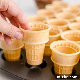 placing ice cream cones into a mini muffin tin