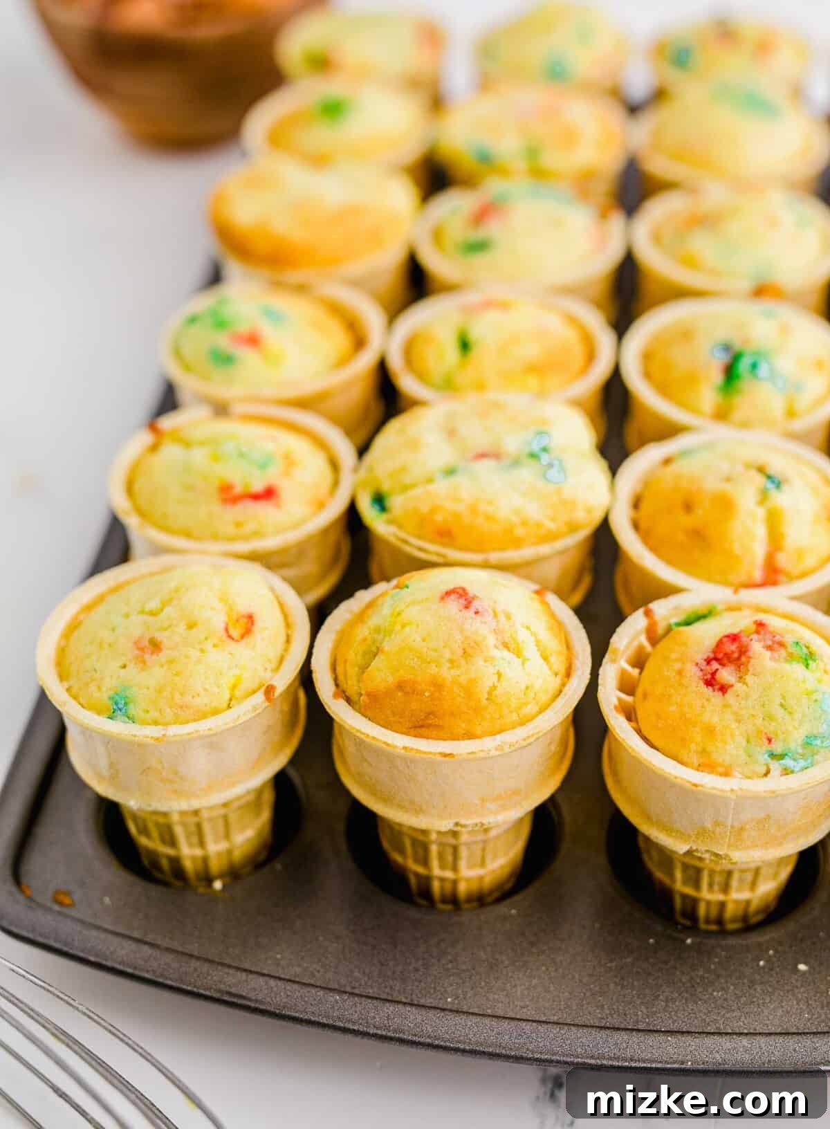 Waffle Cone Cupcakes 4 Funfetti cupcakes are baked into ice cream cones and have no additional toppings, showing their natural state before frosting.