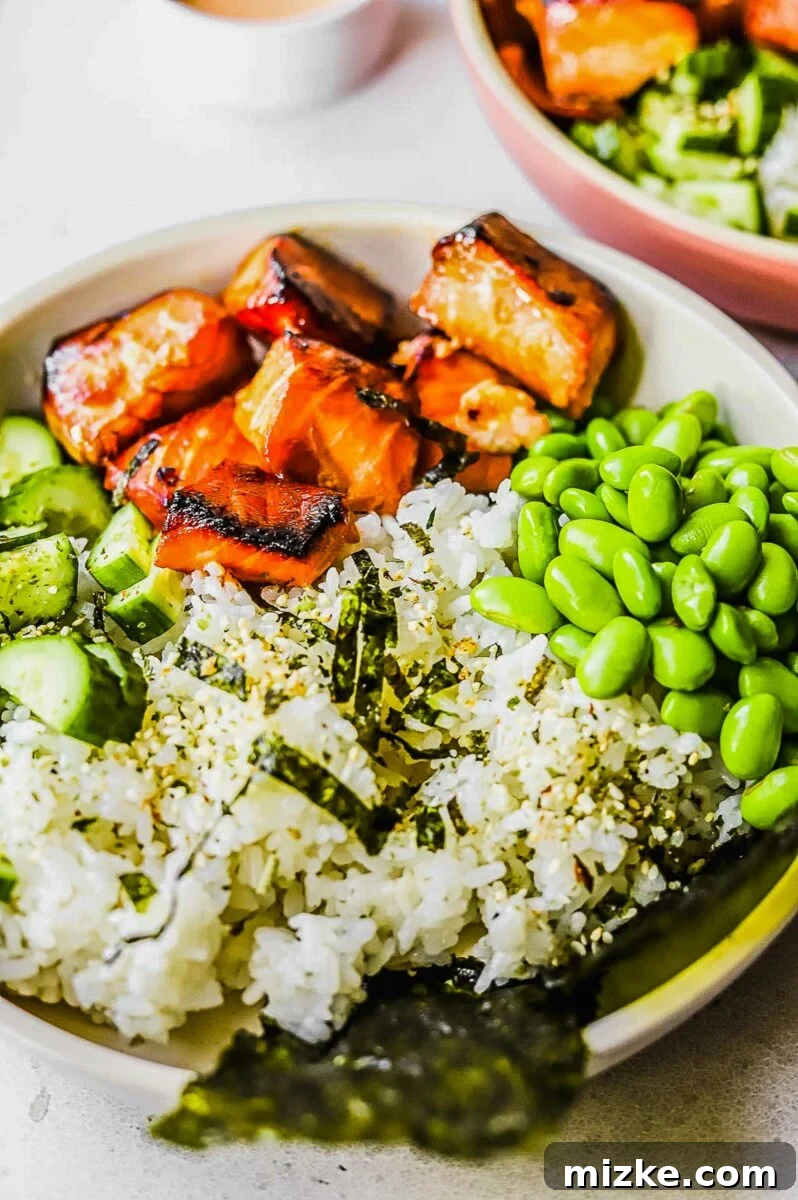 Effortless Salmon Rice Bowls 6 A perfectly prepared salmon rice bowl presented in a clean white bowl, ready to be enjoyed.