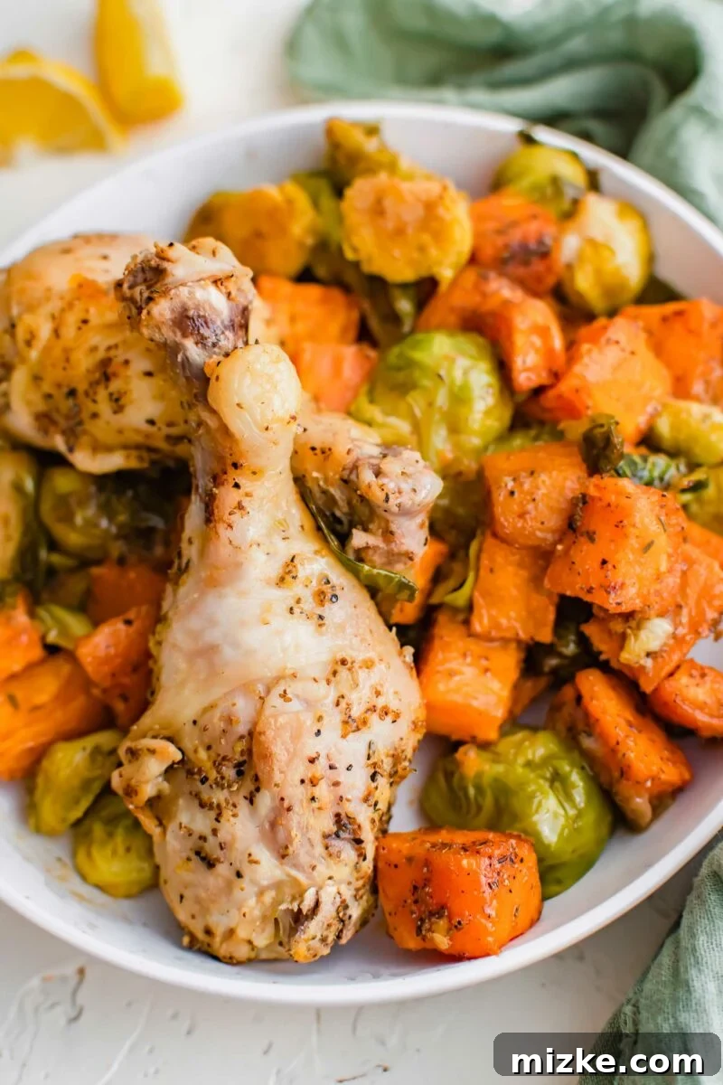 Zesty Golden Drumsticks 9 lemon pepper drumsticks on a white plate with roasted brussels sprouts and sweet potato cubes