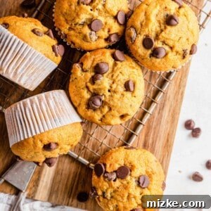 Close-up of a perfectly baked Chocolate Chip Tahini Banana Muffin, showcasing its golden crust and melted chocolate.