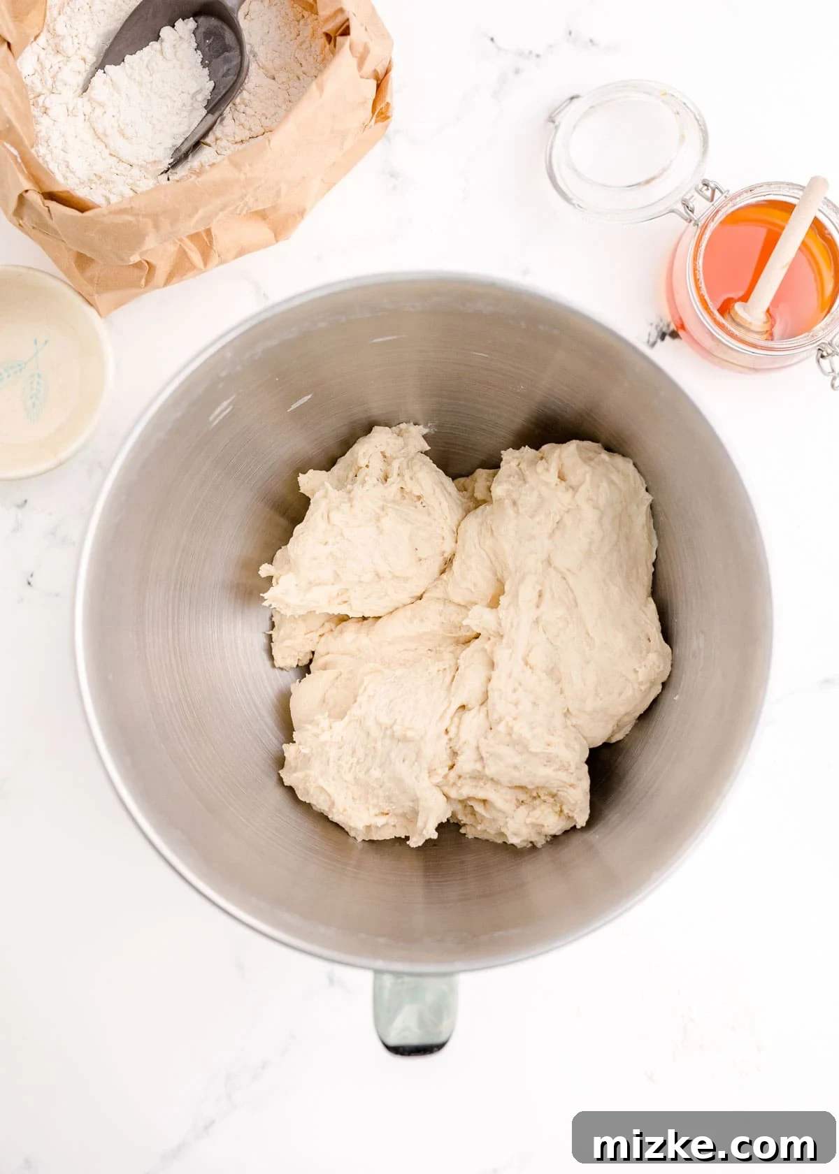Chewy Homemade Bagels From Scratch 8 Bagel dough successfully formed into a firm, moist ball within a metal stand mixer bowl.