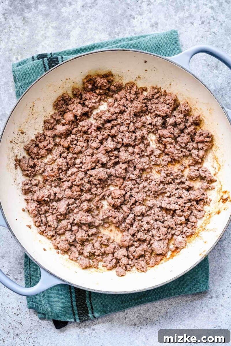 Sizzling Ground Beef Fajitas 6 Browning ground beef in a cast iron skillet, ensuring a crispy texture.