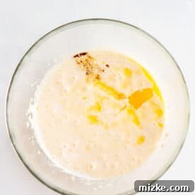 wet batter mixture with egg and vanilla in a clear bowl