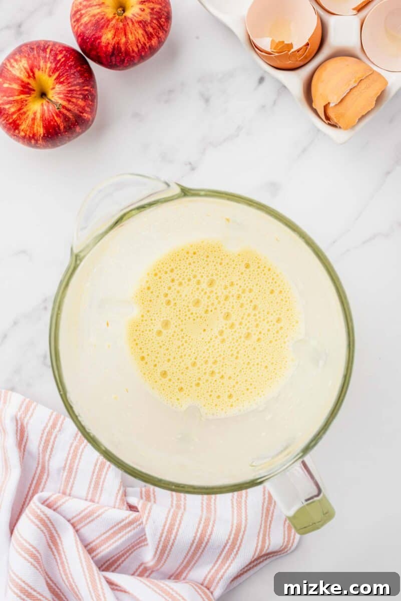 Puffy Apple Cinnamon Dutch Baby 4 The smooth, light-yellow Dutch Baby batter is blended together and rests in a clear blender jar, perfectly combined.