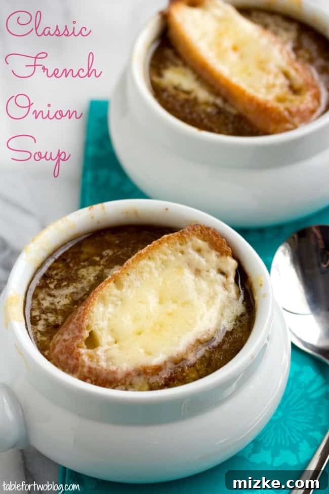 A bubbling crock of classic French Onion Soup, topped with golden-brown Gruyère cheese and a crusty baguette slice.
