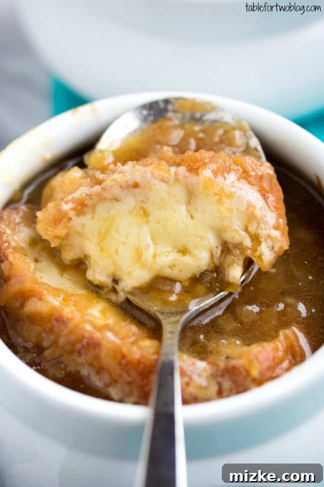 An overhead shot of a single serving of French Onion Soup, emphasizing the beautifully melted and browned cheese crust.