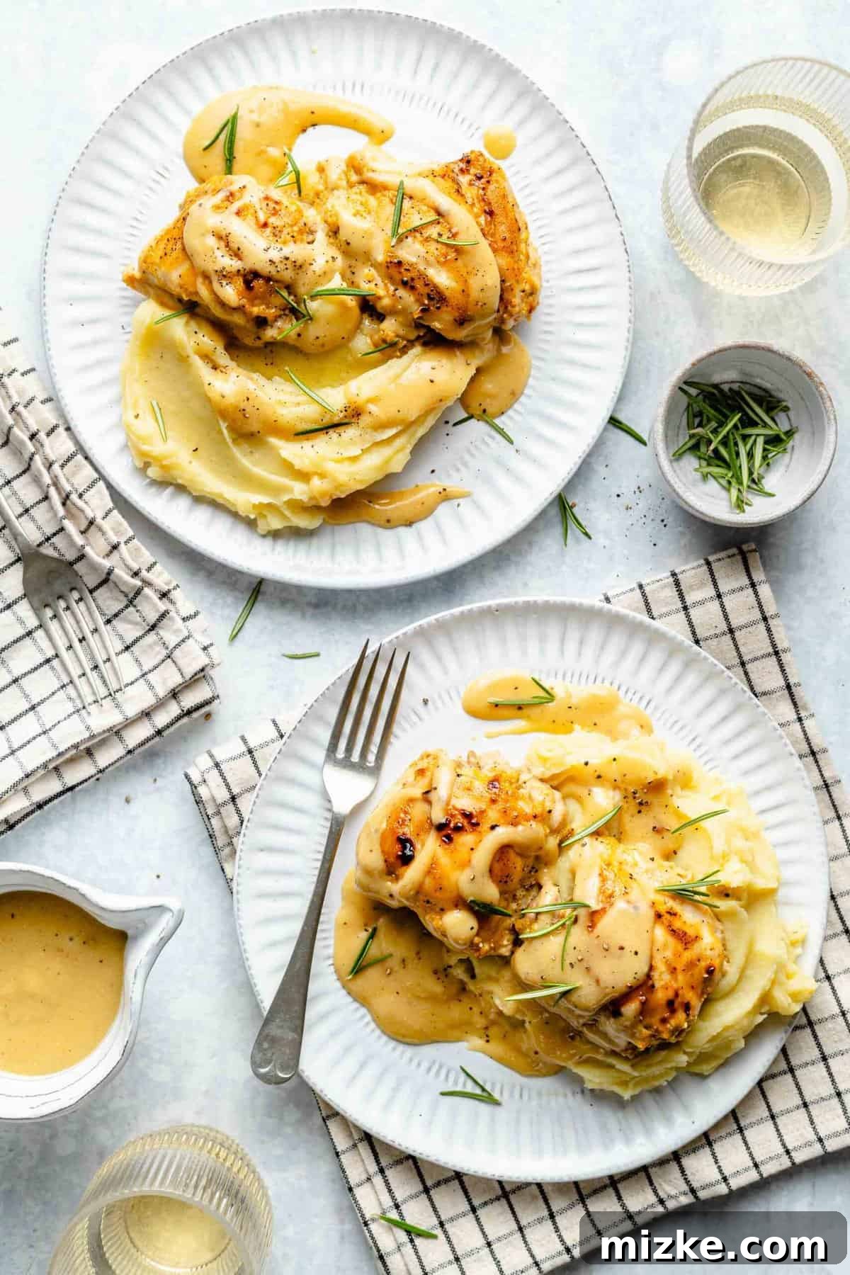 Overhead view of two plates loaded with easy Maple Dijon Yum Yum Chicken, ready to serve. Two plates of Maple Dijon Yum Yum Chicken with parsley garnish.