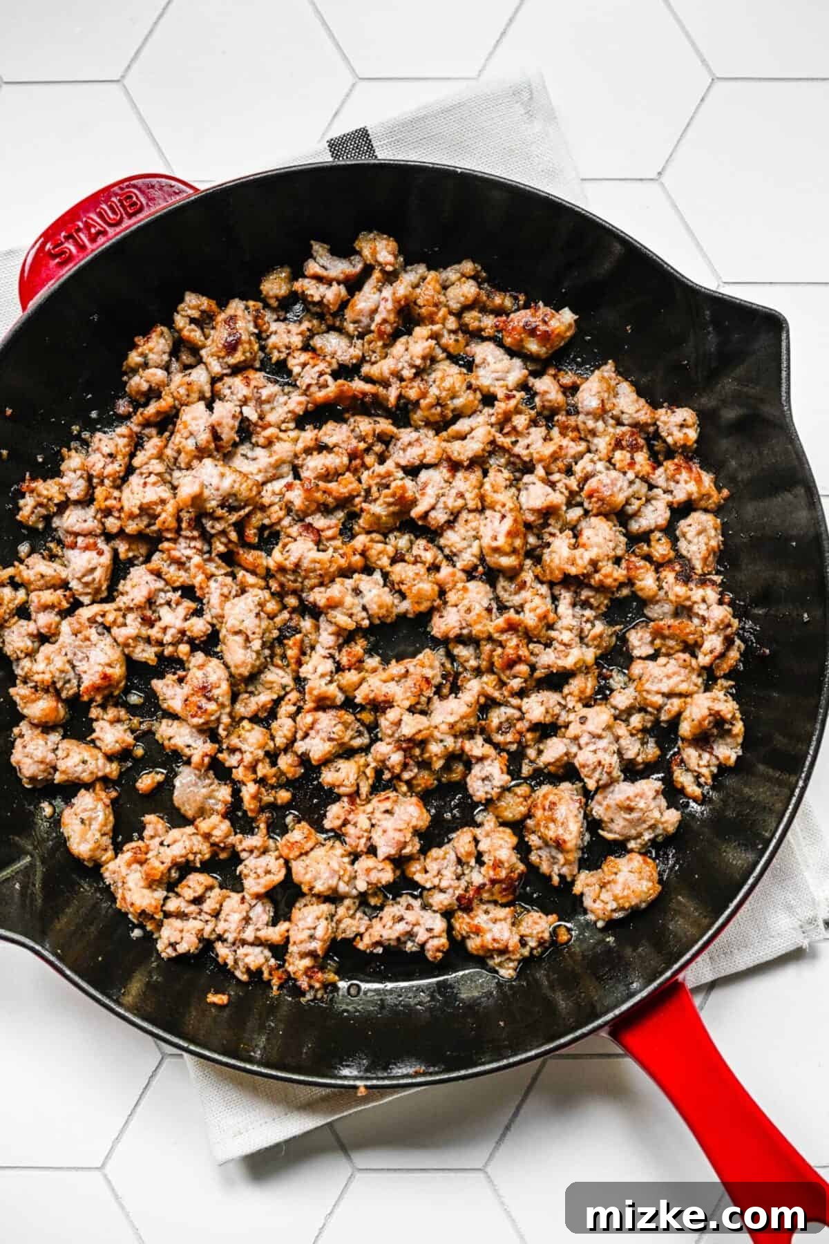 Perfectly browned Italian sausage for your lasagna filling A skillet filled with cooked, browned, and broken up Italian sausage