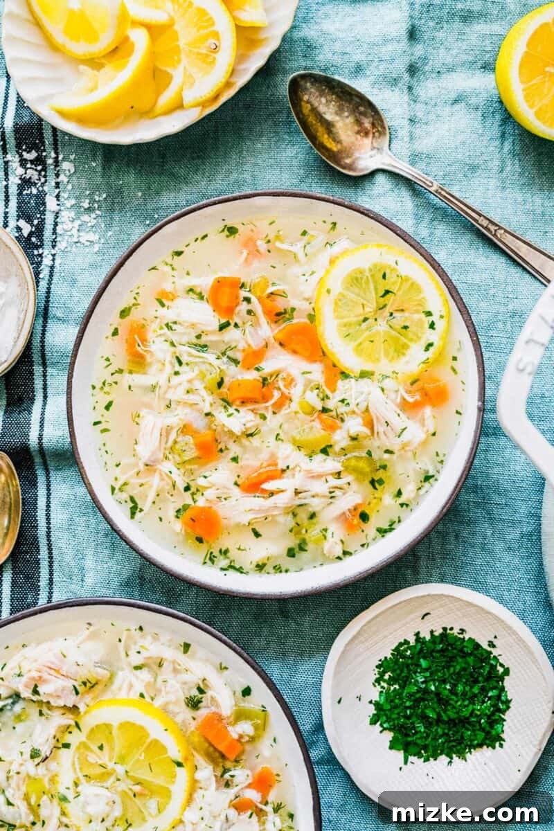 Zesty Lemon Chicken Rice Soup 9 Overhead shot of a rustic bowl filled with steaming lemon chicken and rice soup, garnished with fresh herbs