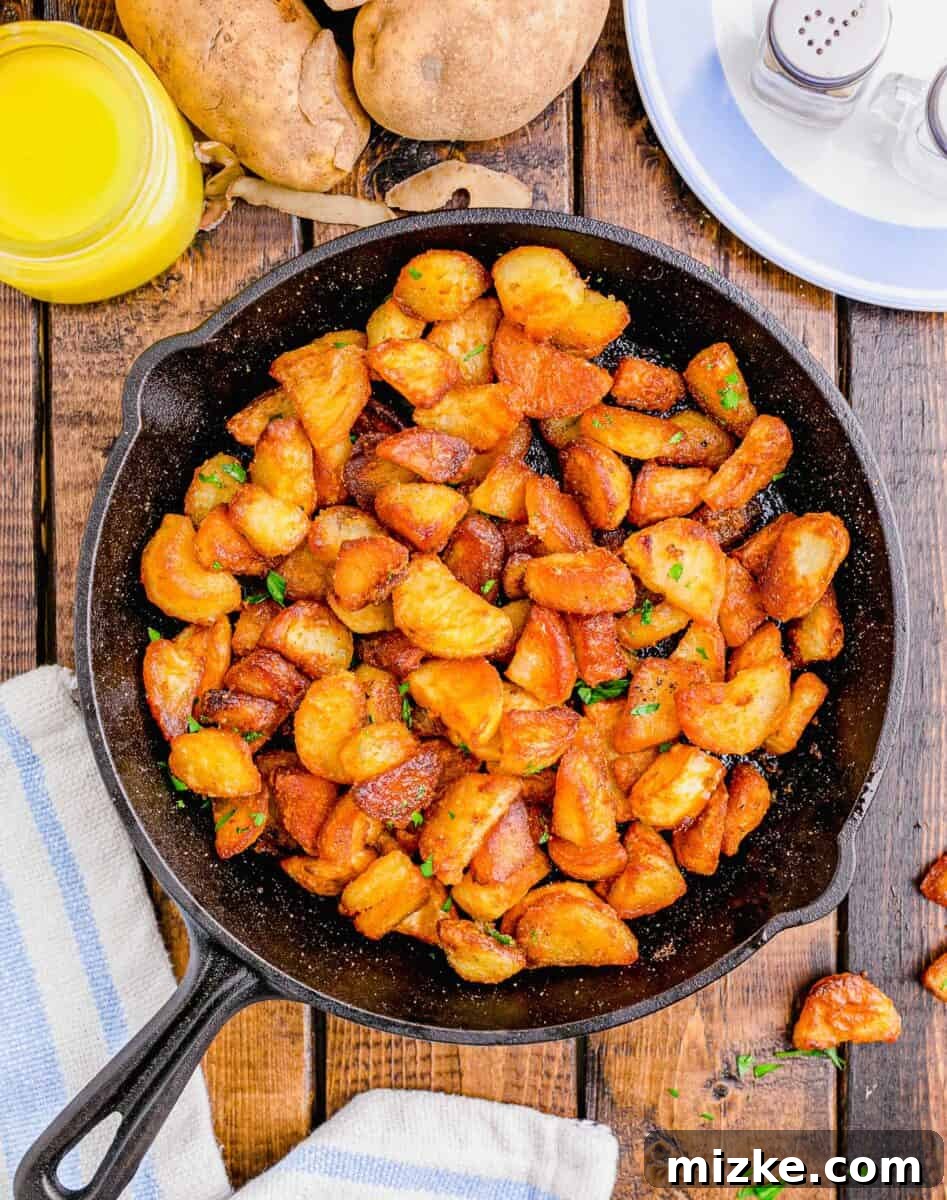 Shatteringly Crisp Duck Fat Potatoes 2 Overhead shot of perfectly crispy duck fat potatoes served in a rustic cast iron skillet