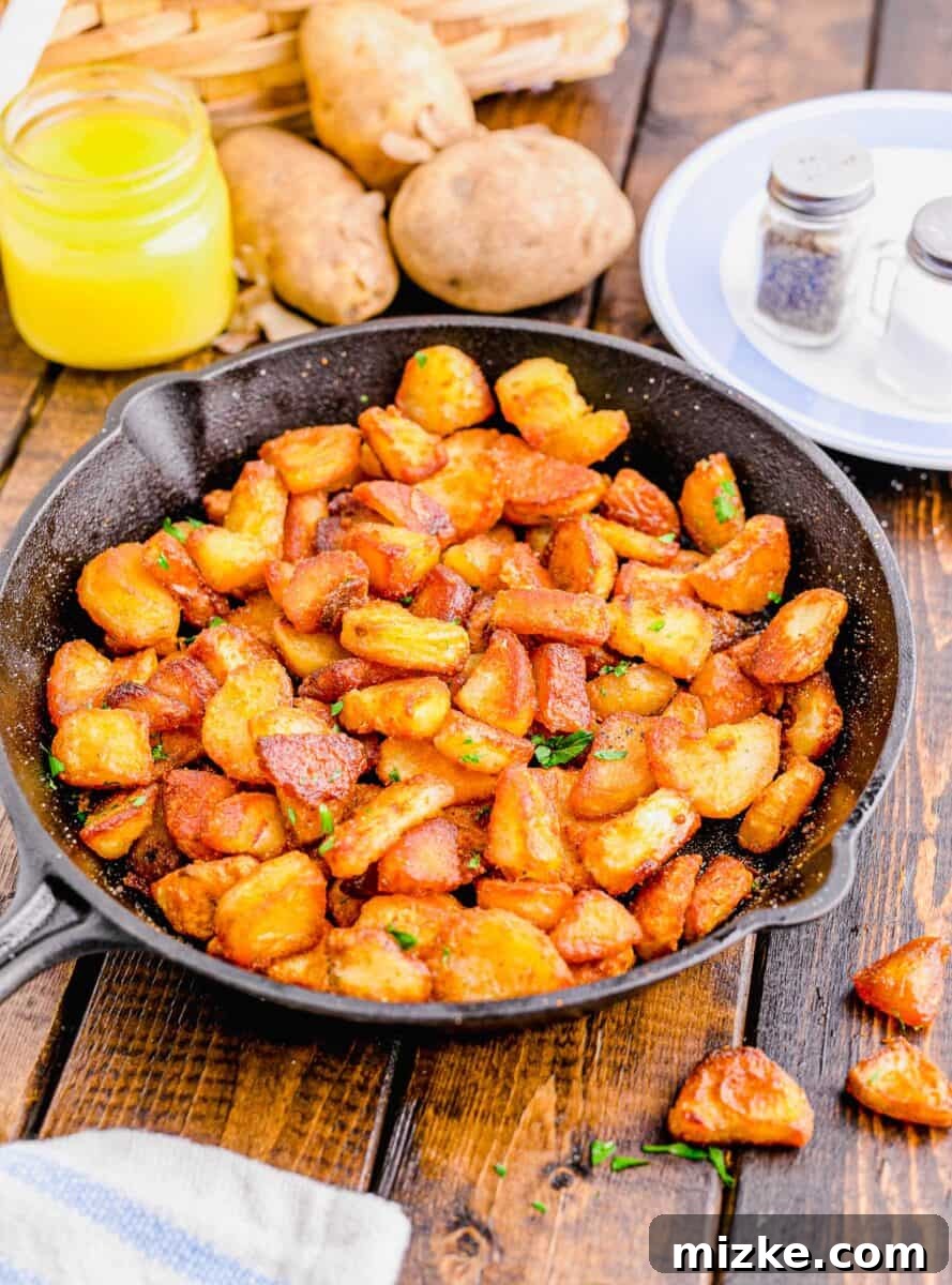 Shatteringly Crisp Duck Fat Potatoes 9 45-degree angle shot showcasing a generous serving of irresistibly crispy duck fat potatoes in a cast iron skillet, ready to be enjoyed