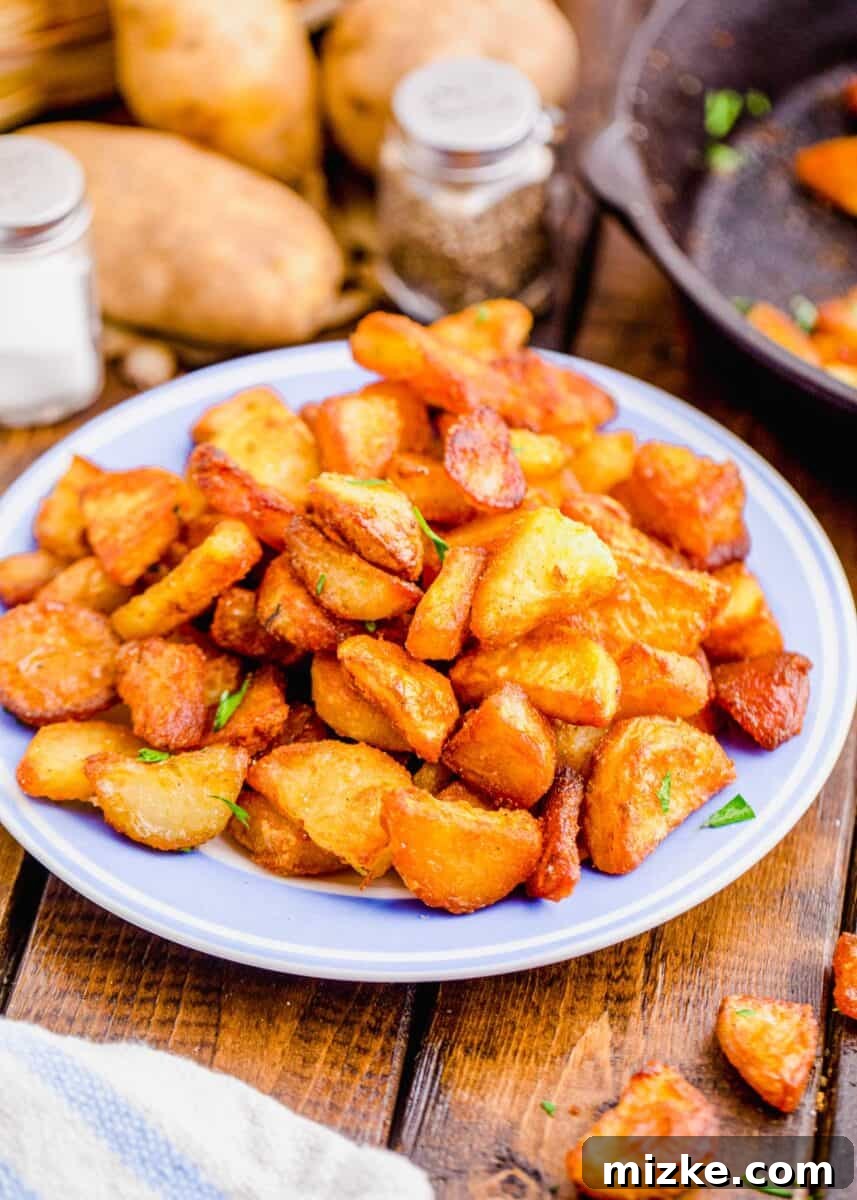 Shatteringly Crisp Duck Fat Potatoes 10 Artfully plated duck fat potatoes piled on a stylish light blue ceramic plate, ready for serving