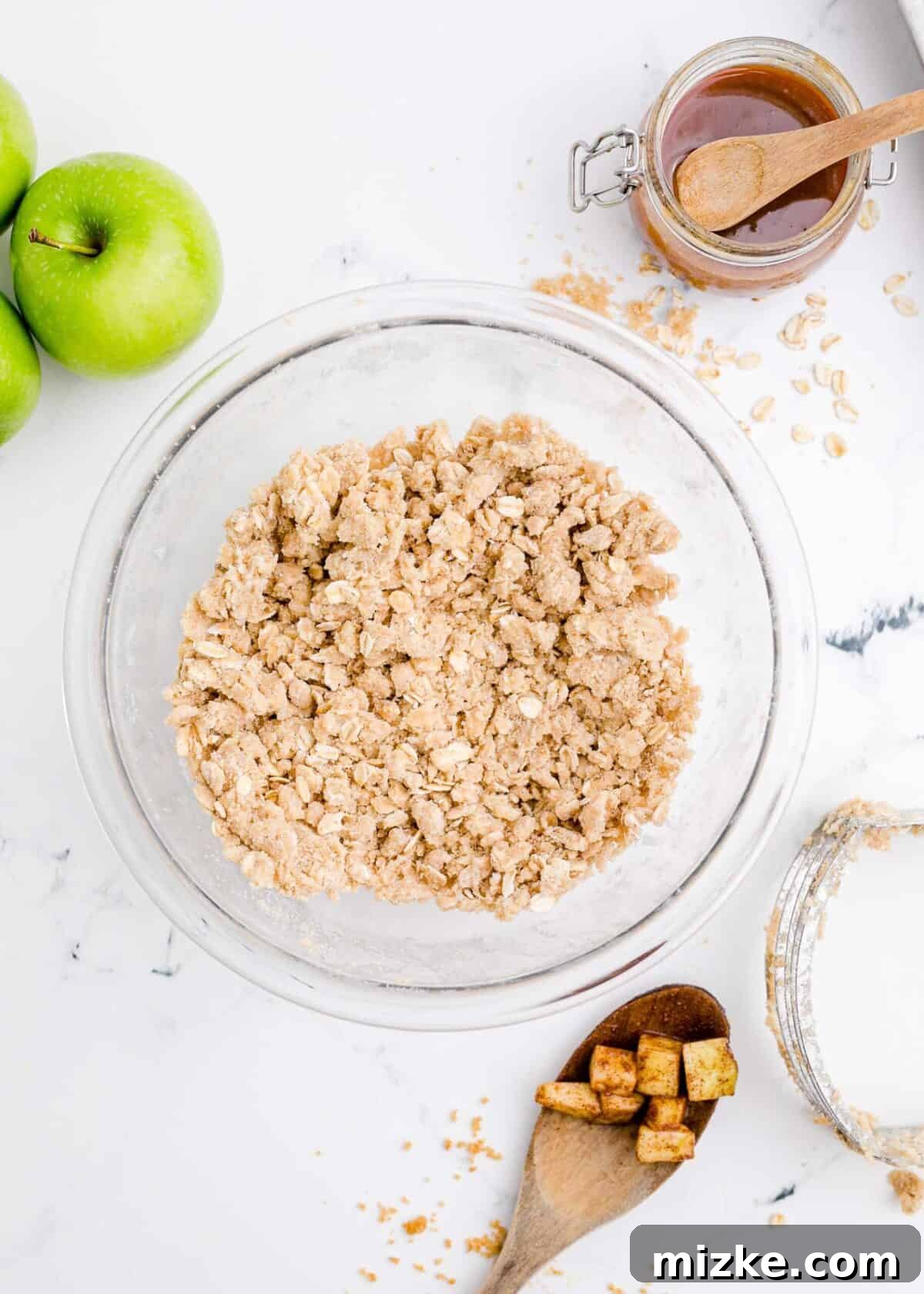 Oat, cinnamon, and brown sugar topping ready to be sprinkled. A rustic bowl showcasing the delightful oat, cinnamon, and brown sugar topping mixture, ready for the cheesecakes. It sits beside fresh apples, a jar of honey, and a wooden spoon, emphasizing the natural, wholesome ingredients.
