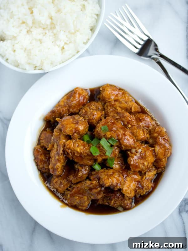 Delicious and Nutritious General Tso Chicken Recipe Serving of Lightened Up General Tso Chicken garnished with green onions.