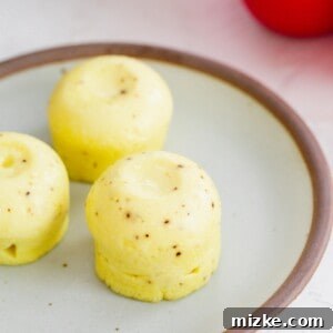 Instant Pot egg bites with black pepper speckles on a ceramic plate