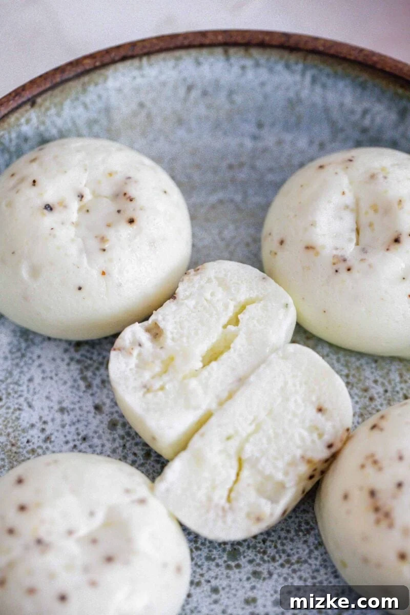 Fluffy Instant Pot Egg White Bites 11 An egg white egg bite cut in half, showcasing its incredibly fluffy and airy interior texture.