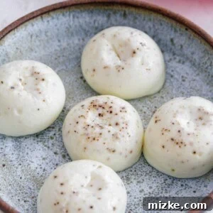 Close-up image of fluffy Instant Pot egg white egg bites on a speckled blue plate.