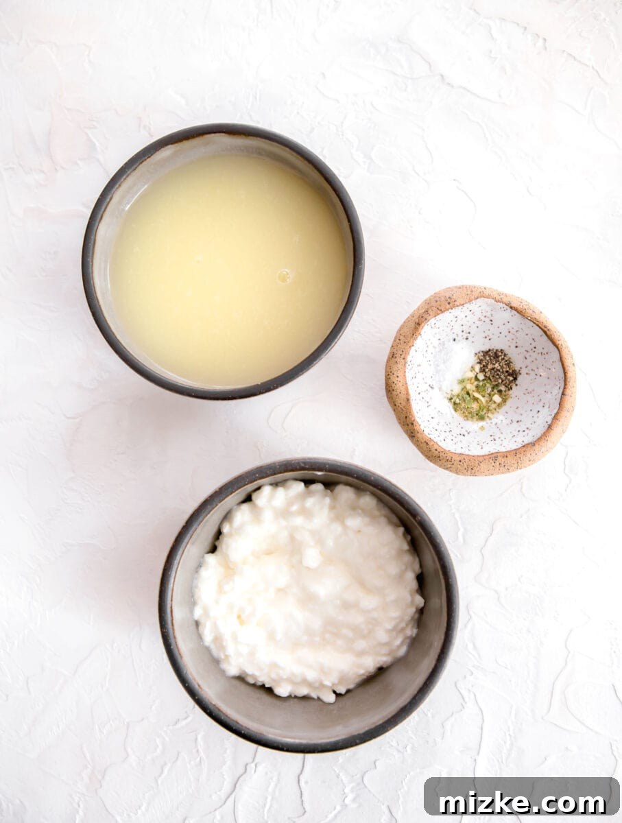 Fluffy Instant Pot Egg White Bites 4 Ingredients laid out for Instant Pot egg white egg bites: liquid egg whites, a bowl of cottage cheese, and various seasonings.