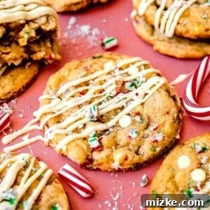 peppermint white chocolate cookie with white chocolate drizzle and crushed candy canes on top