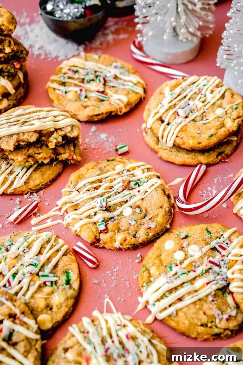 White Chocolate Peppermint Bliss Cookies 10 peppermint white chocolate cookies on a pink backdrop along with all the other cookies and candy canes