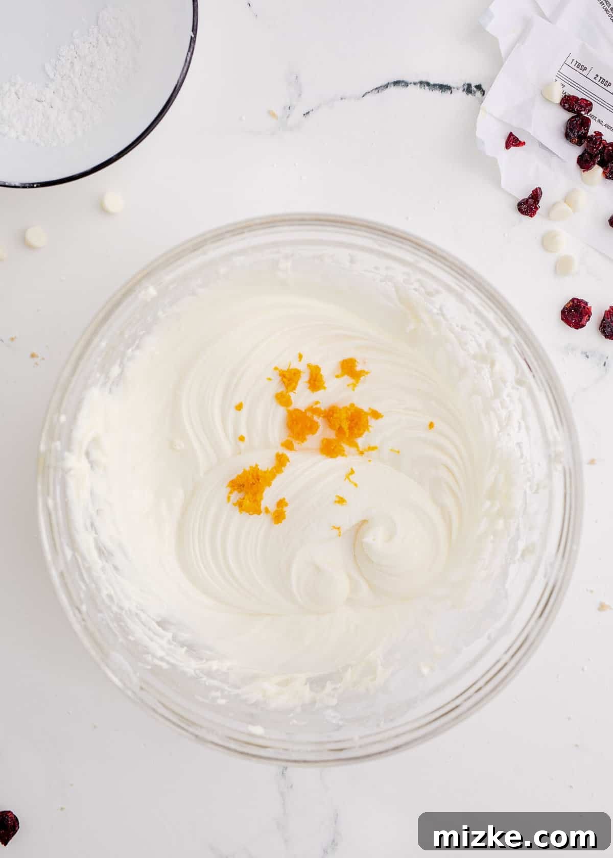 Bake Your Own Cranberry Bliss 14 Fresh orange zest being added to powdered sugar in a bowl.