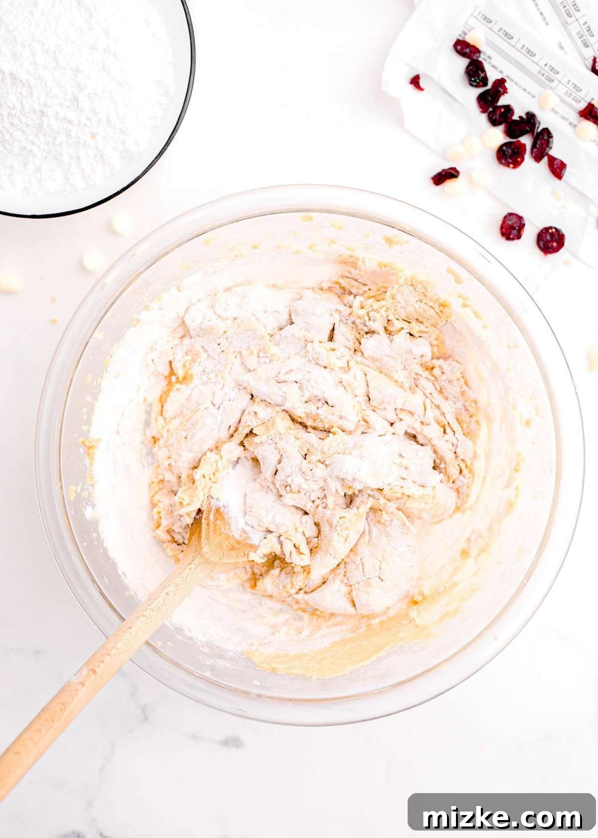 Bake Your Own Cranberry Bliss 9 Gradually combining dry ingredients into the wet ingredients mixture, stirring gently.