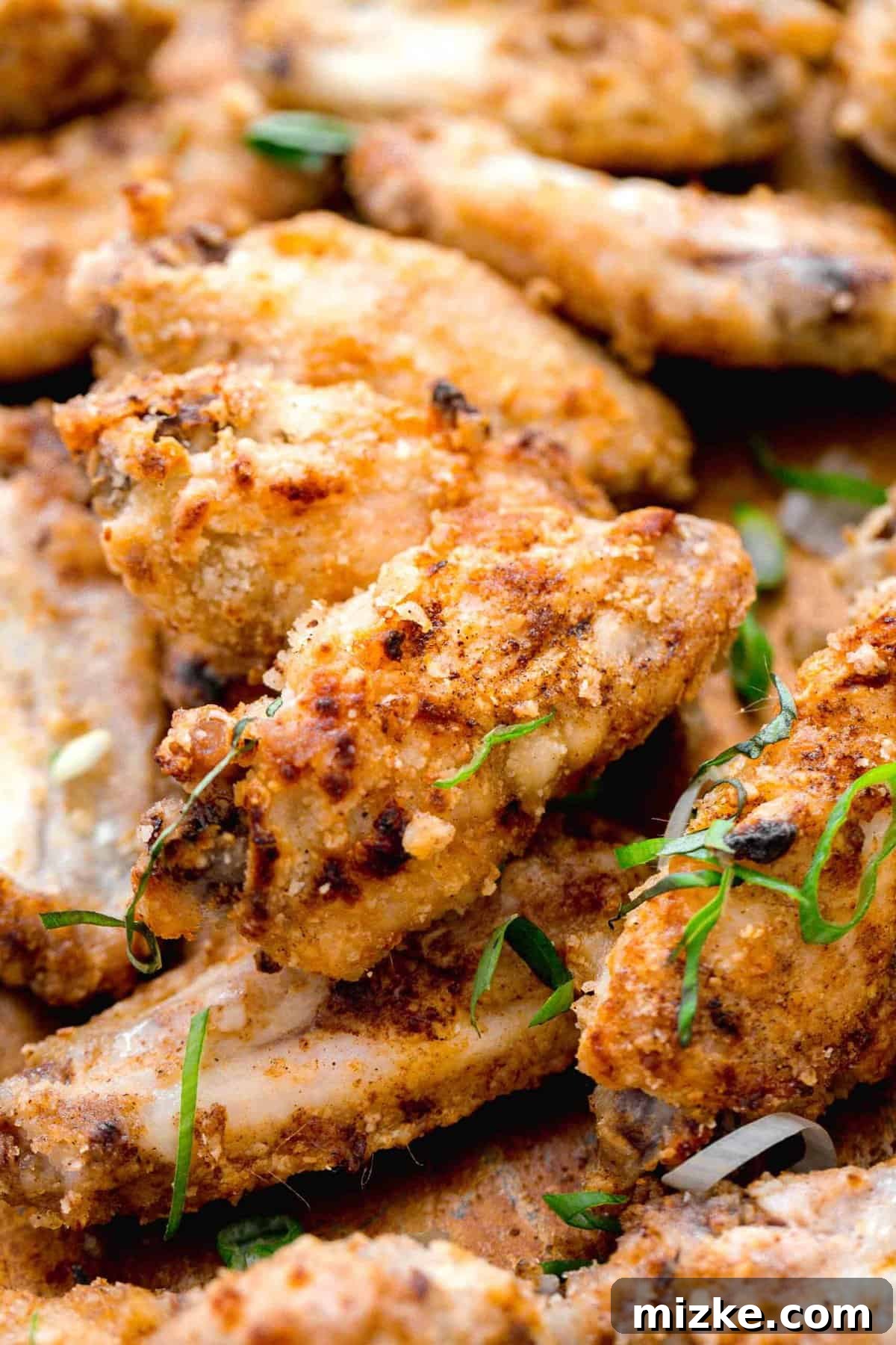 Close-up shot of a single crispy Chinese salt and pepper chicken flat wing, showcasing its golden-brown crust and juicy interior.