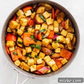 sauce added into the tofu and eggplant mixture in the skillet