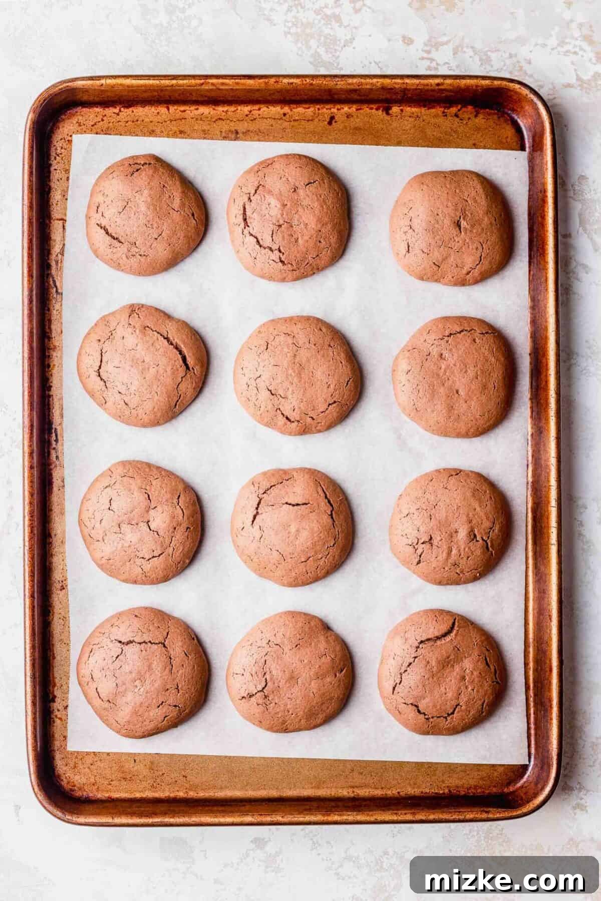 These chocolate peppermint lofthouse cookies are moist, decadent, and bursting with flavor, making them the perfect Christmas cookie. 12 baked chocolate peppermint lofthouse cookies, on a baking sheet