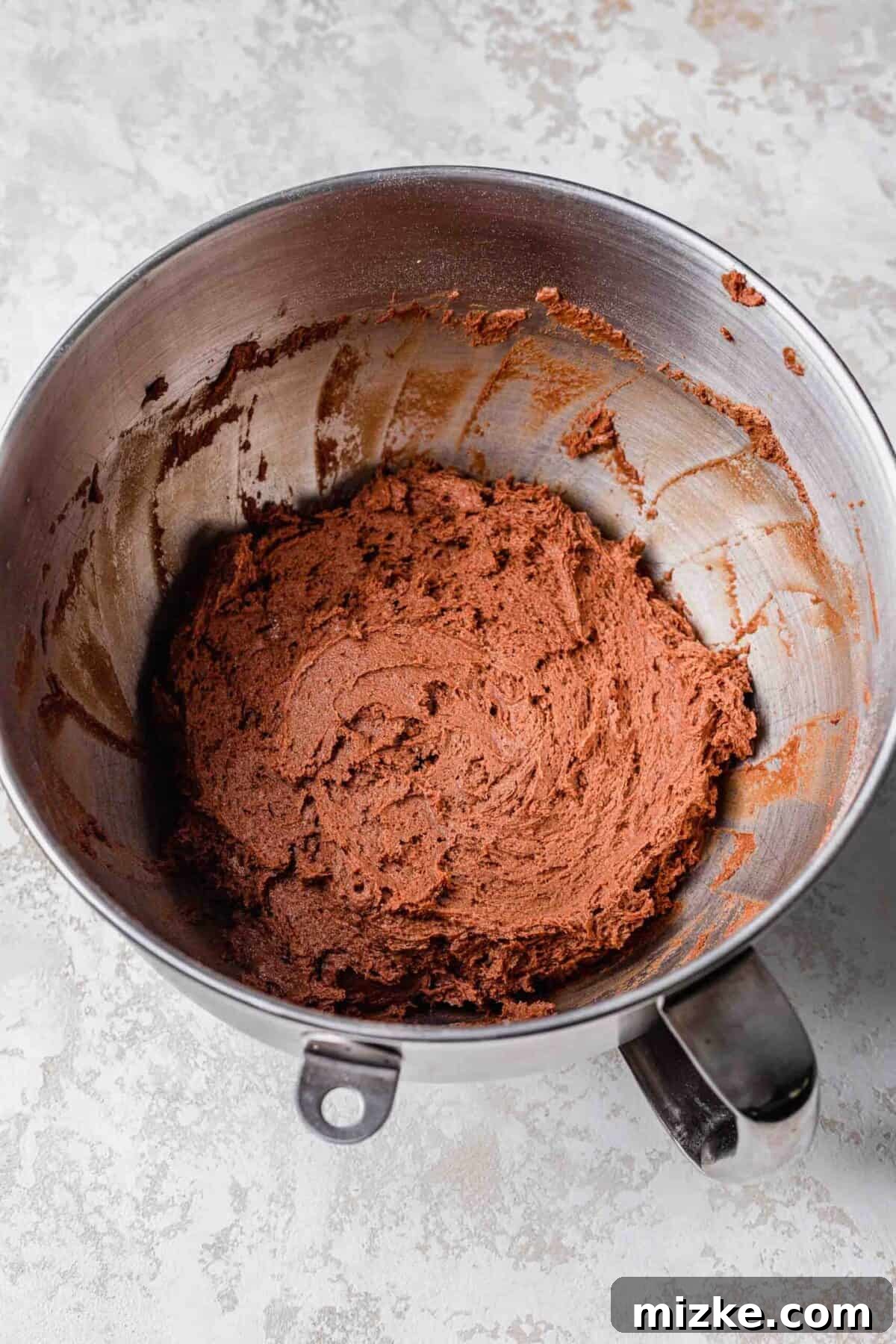 These chocolate peppermint lofthouse cookies are moist, decadent, and bursting with flavor, making them the perfect Christmas cookie. A stand mixer bowl filled with chocolate cookie dough