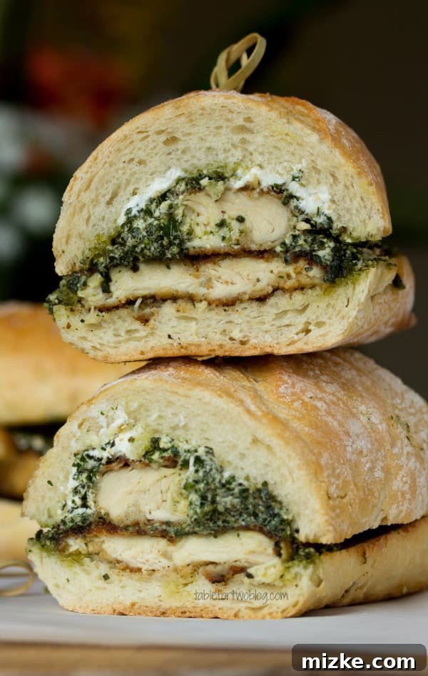 Goat Cheese Pesto Chicken Sandwich from www.tablefortwoblog.com A perfectly assembled Goat Cheese Pesto Chicken Sandwich, showing crisp bread and rich fillings.