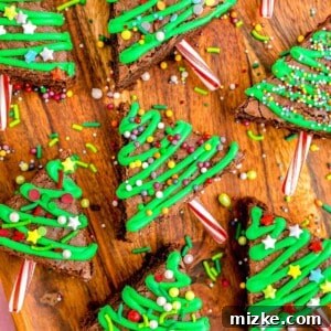 Christmas tree brownies with round sprinkles on a wooden background