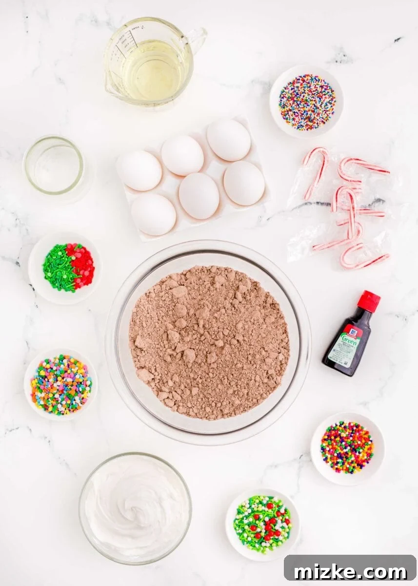 A vibrant flat lay of ingredients laid out for making Christmas tree brownies, including a box of brownie mix, liquid oil, fresh eggs, an assortment of colorful sprinkles, a white jar of frosting, a bottle of green food coloring, and a few festive candy canes, all ready for baking and decorating.