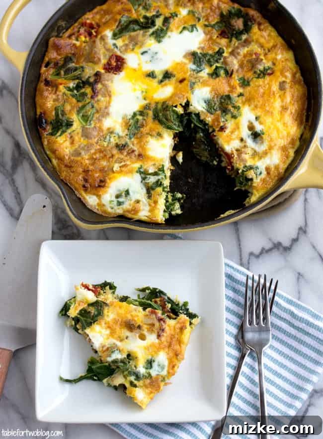 This healthy vegetable frittata recipe is an easy, high-protein breakfast filled with ground turkey, kale, onions, and sun-dried tomatoes. Overhead view of a slice of turkey and vegetable frittata on a square plate, next to a full frittata in a cast iron skillet.