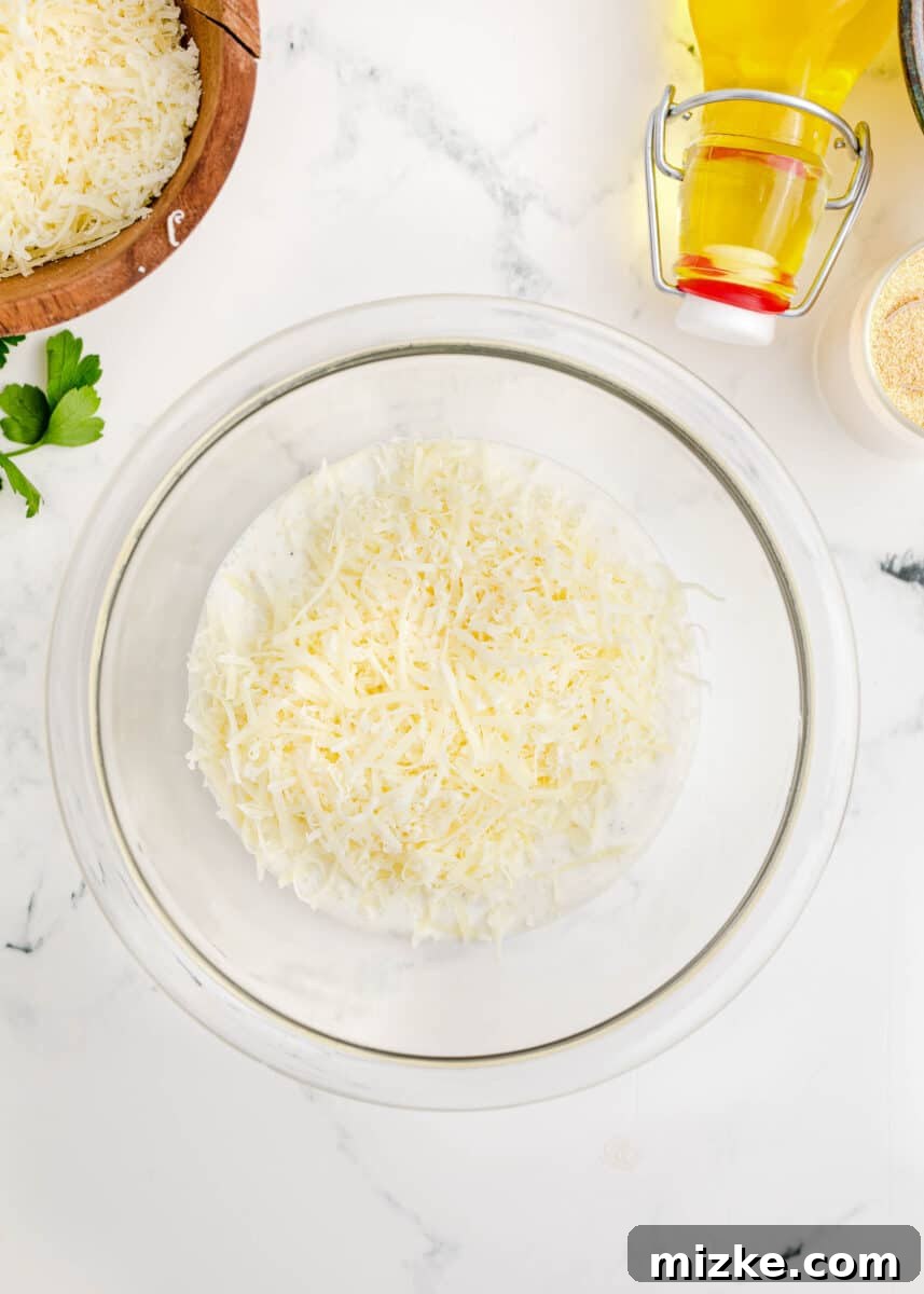 Parmesan cheese and ranch dressing being stirred together in a bowl.