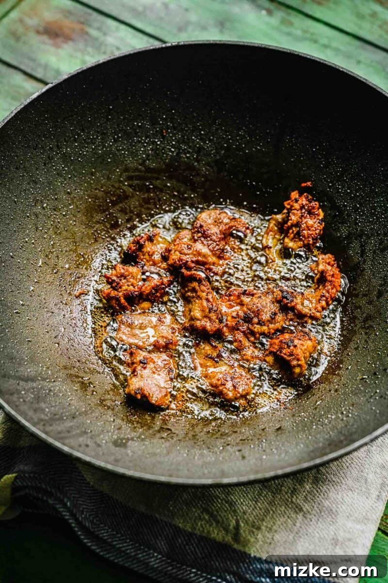 This Beijing Beef Panda Express Copycat will beat takeout any day. Sticky, sweet, tangy, slightly spicy sauce marries crispy bites of beef with sautéed veggies. Crispy Beijing beef sizzling and frying in hot oil in a wok.