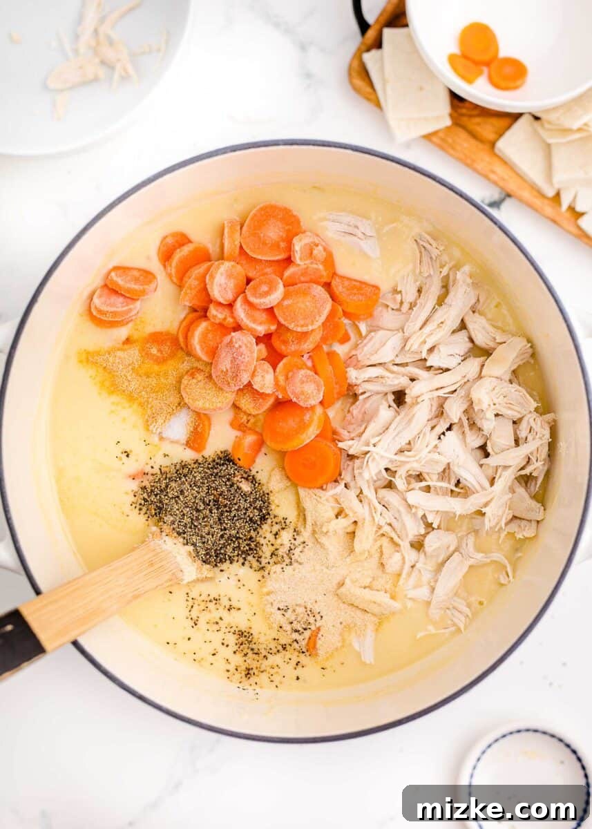 Comfort Chicken with a Tortilla Twist 7 frozen carrots, shredded chicken, and seasonings added to a large pot with chicken broth and cream soups