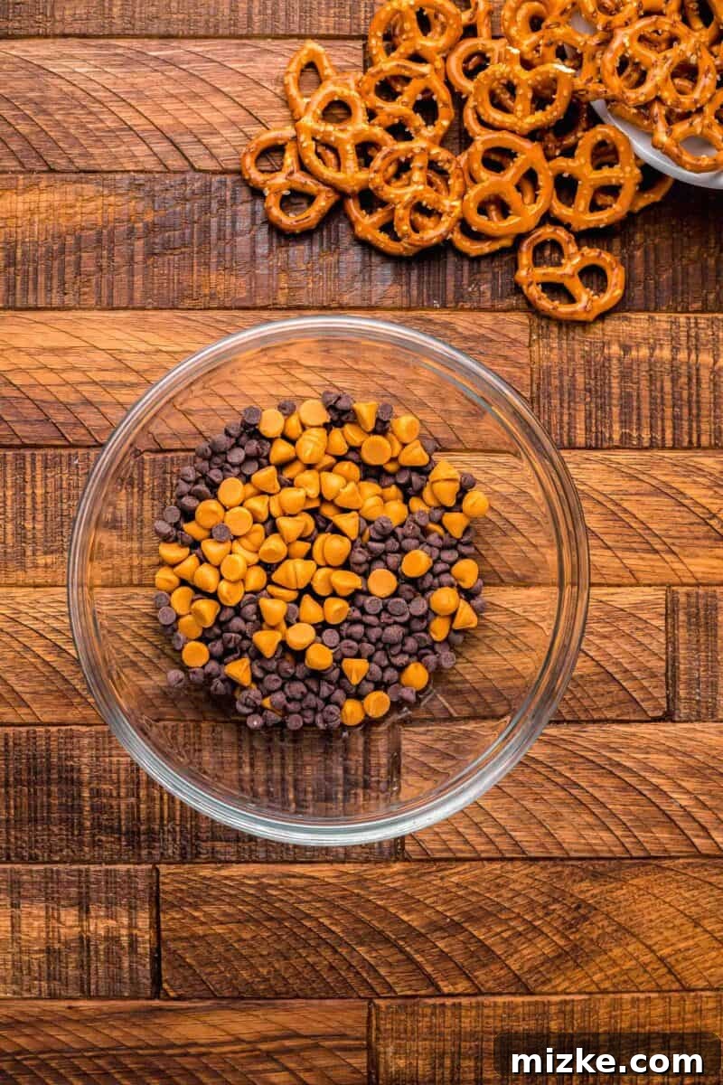 Butterscotch and chocolate chip morsels in a clear glass bowl, showcasing the elements for the dipping sauce