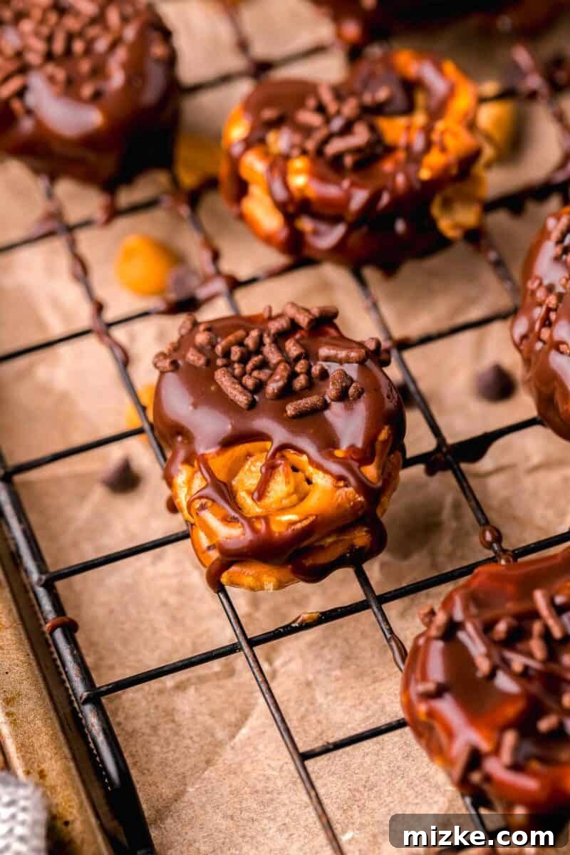 Peanut butter pretzel bites with chocolate sprinkles on half-dipped chocolate pretzels, arranged artfully for serving