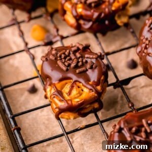 Peanut butter pretzel bites with chocolate sprinkles on half dipped chocolate pretzels
