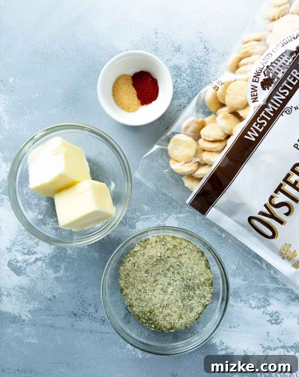 The essential ingredients for ranch oyster crackers laid out: a bag of oyster crackers, butter, ranch seasoning, garlic powder, and smoked paprika.
