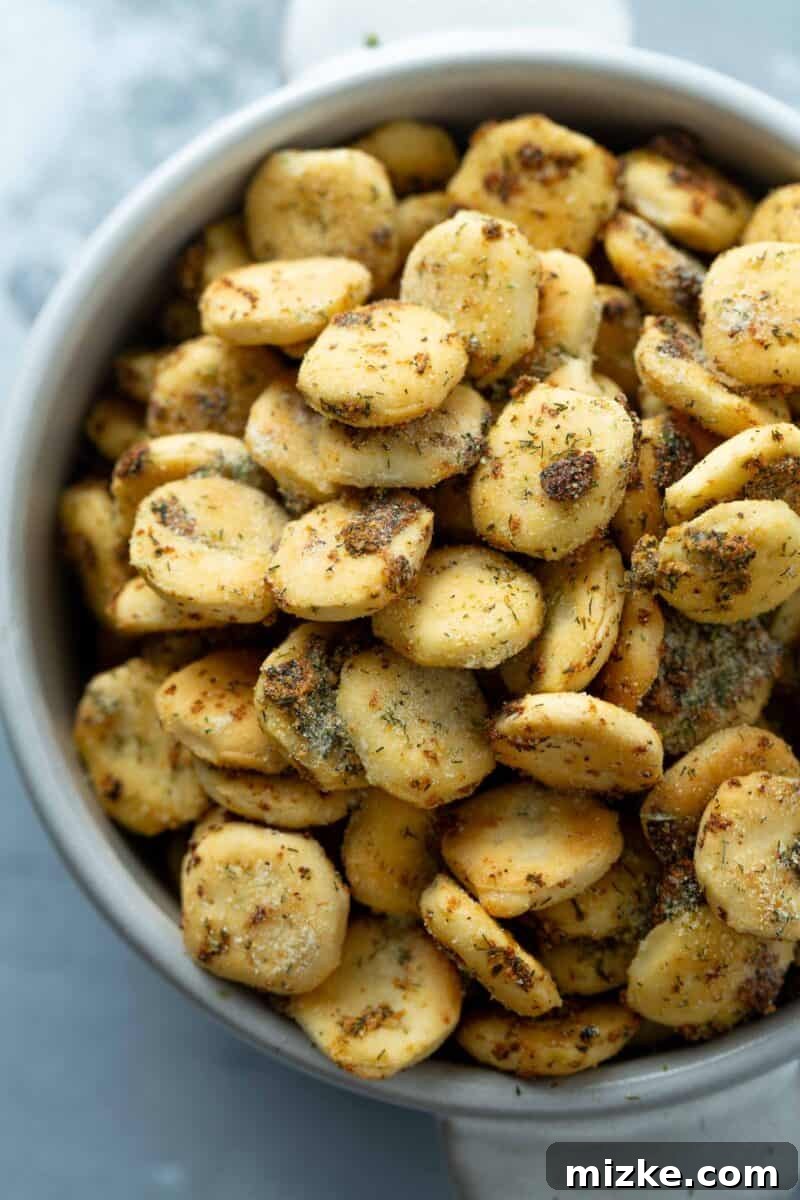 An inviting overhead shot of perfectly seasoned ranch oyster crackers spread out, showcasing their golden color and crisp texture.