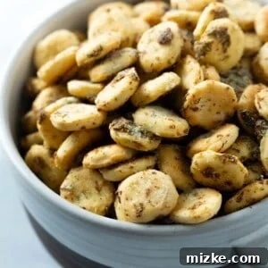 A ceramic crock filled with golden-brown ranch oyster crackers.