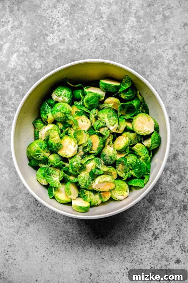 Golden Bacon Roasted Brussels Sprouts 5 Halved brussels sprouts neatly arranged in a large mixing bowl, ready for seasoning.