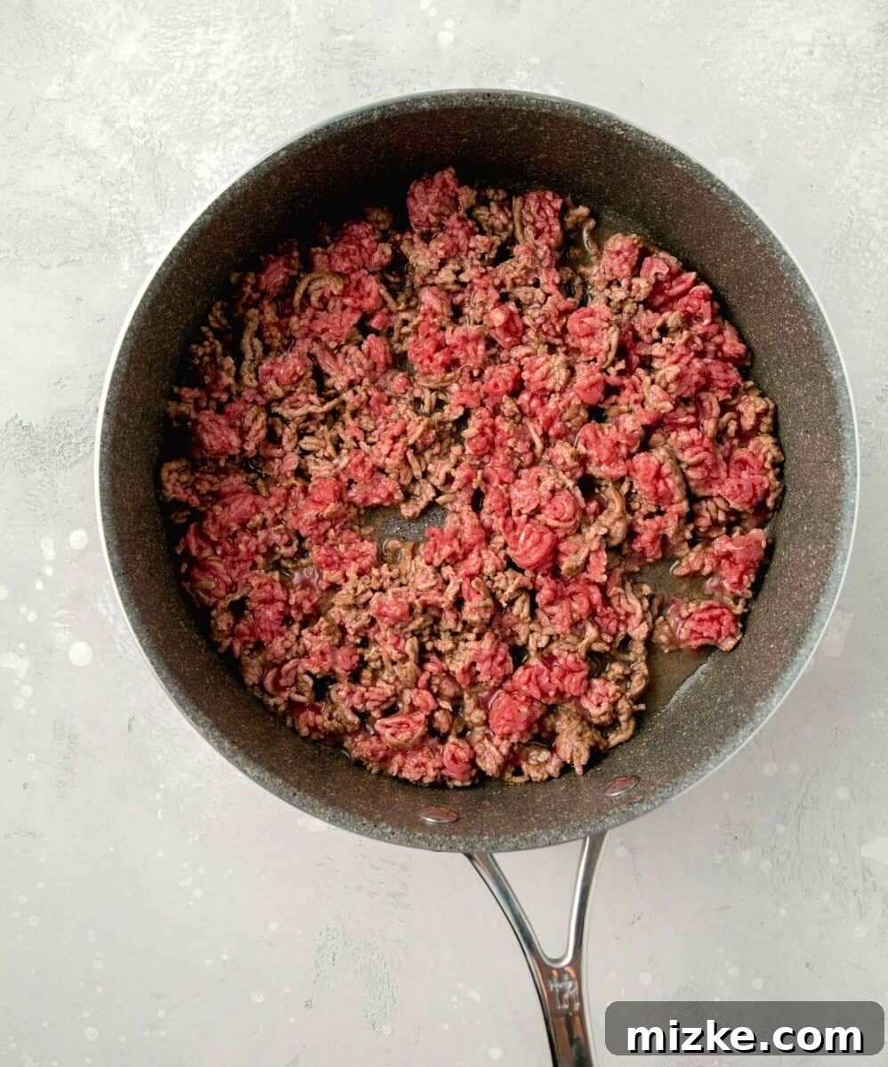 Step 1: Browning the ground beef in the skillet. Browning and breaking apart ground beef in a large skillet over medium-high heat.