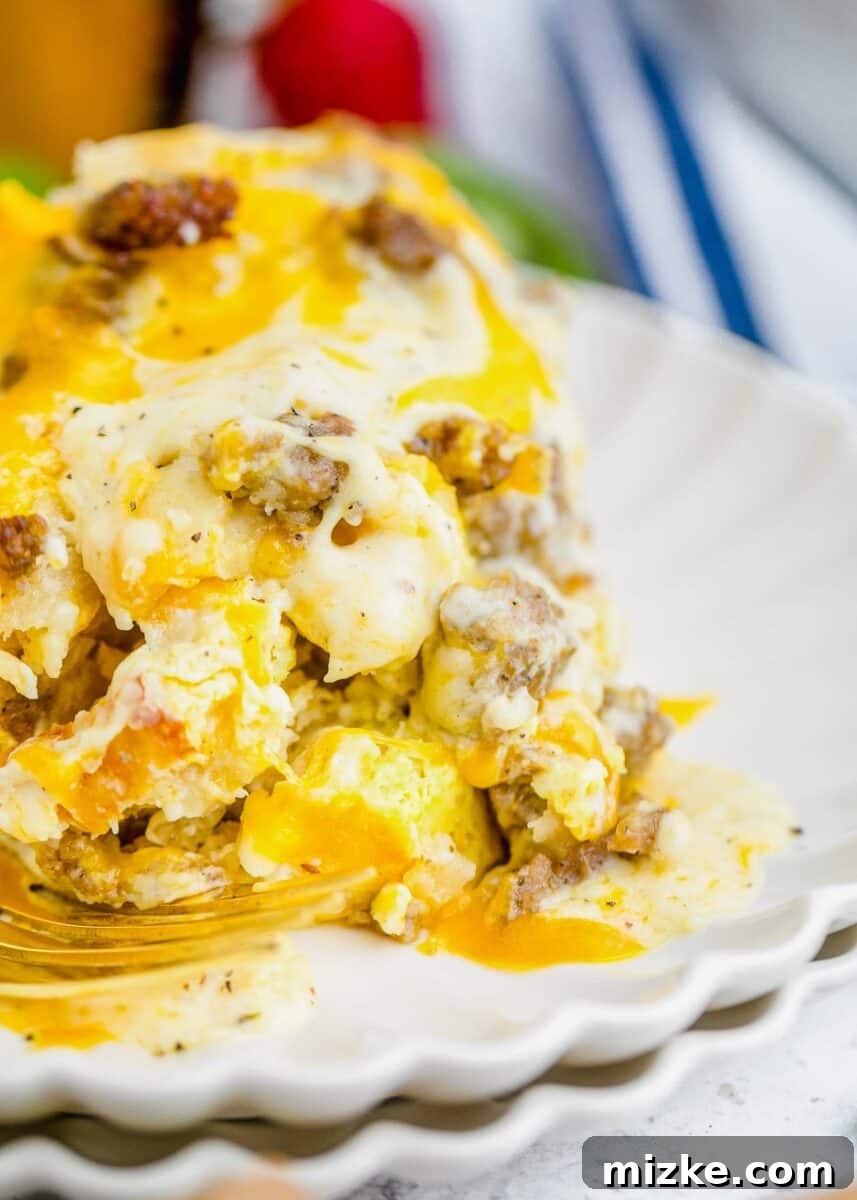 Southern Comfort Biscuit Bake 13 up close image of biscuits and gravy casserole on a scalloped white plate