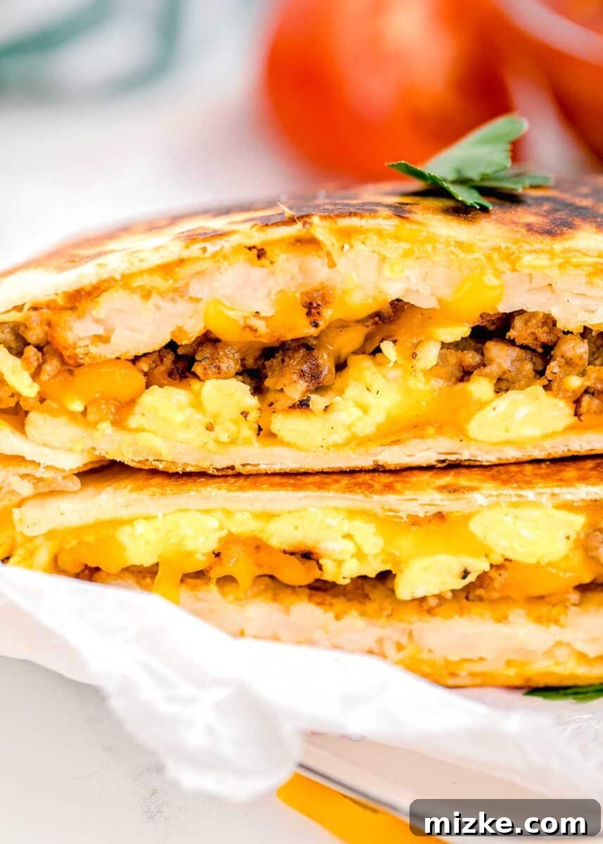 Sunrise Crunch Fold 13 Beautifully halved breakfast crunchwraps are carefully stacked on top of one another, revealing their tempting layers of savory filling.